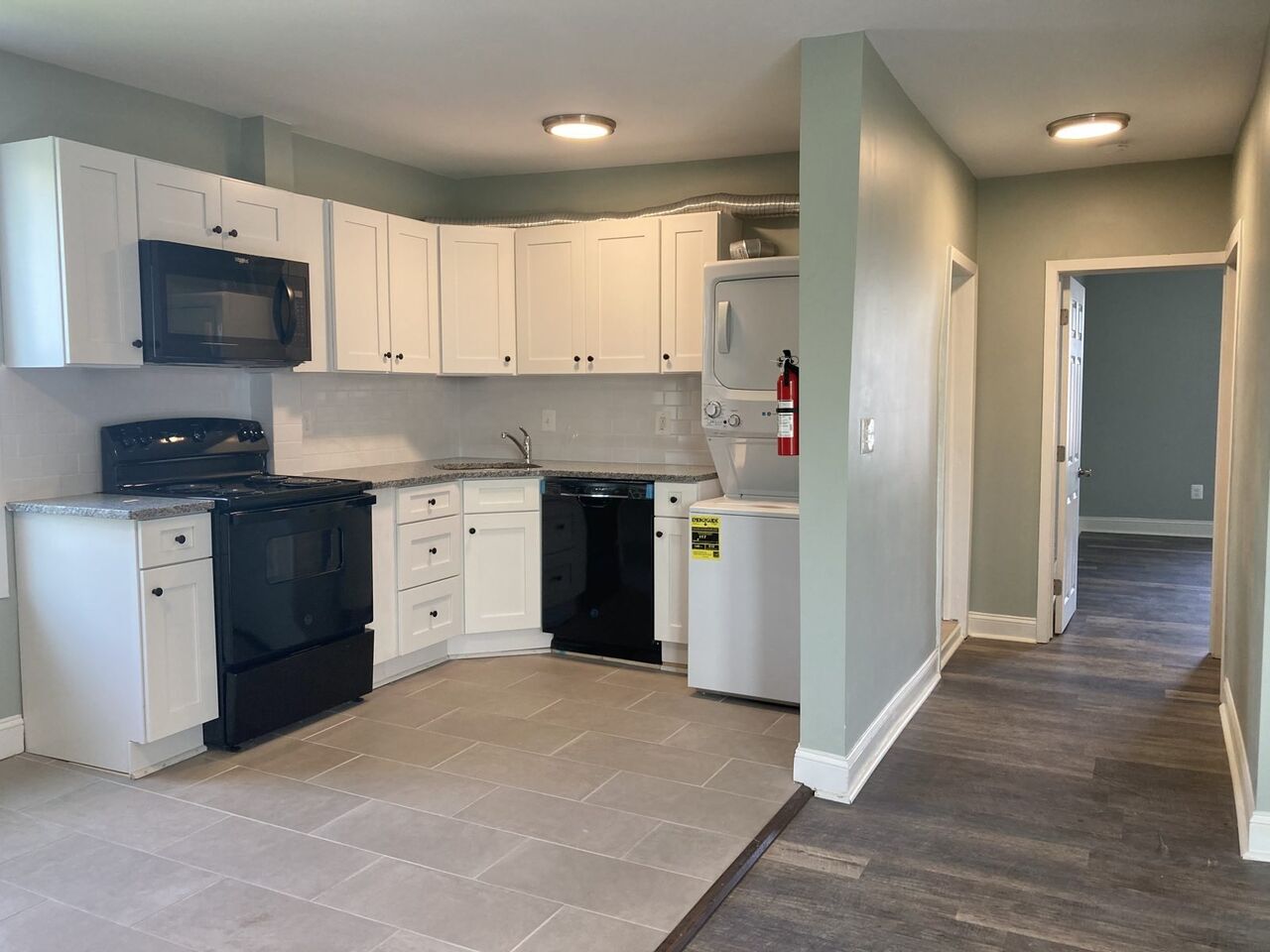 Open kitchen with an in-unit stacked washer and dryer